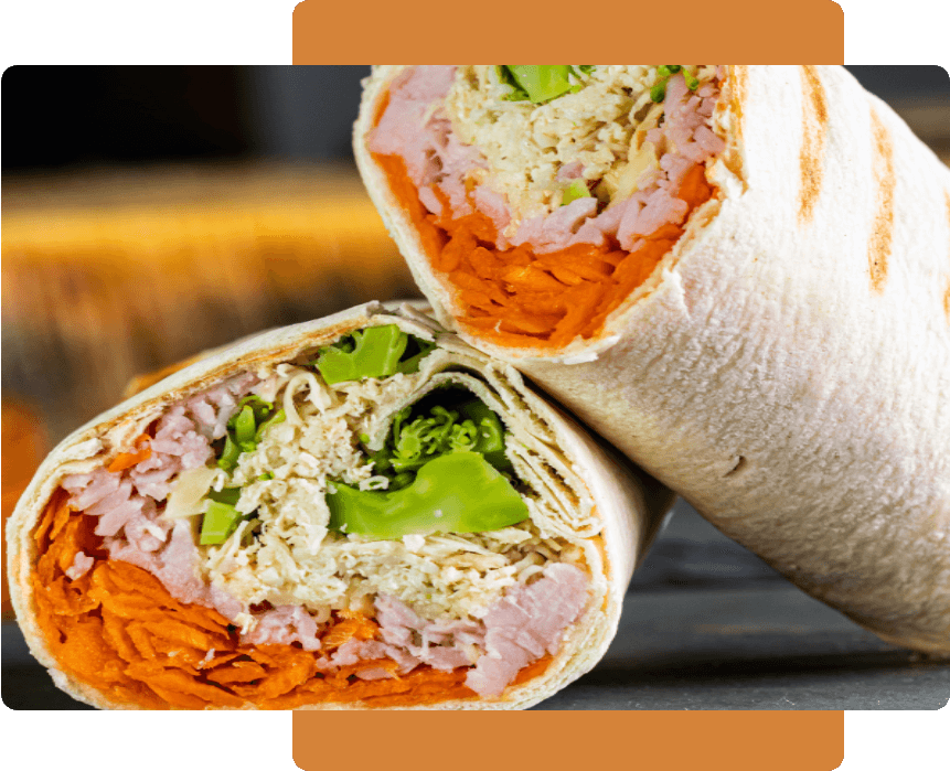 A close up of a wrap with meat and vegetables